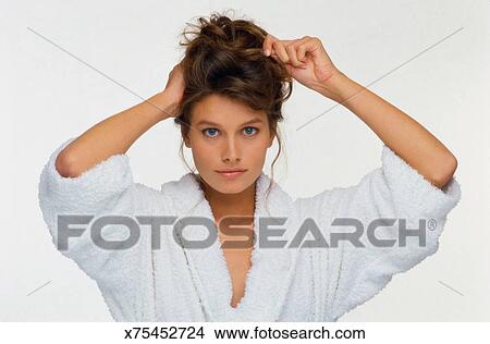 Woman In Robe Pinning Up Hair Picture X75452724 Fotosearch