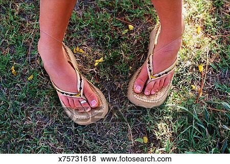 Pictures of Feet of woman wearing sandals standing pigeon-toed ...