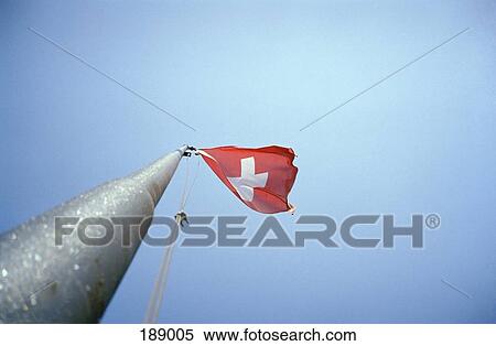 Flag of Switzerland flapping in wind View Large Photo Image Stock Photography - Flag of Switzerland flapping in wind. Fotosearch