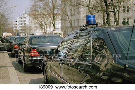 Row of police cars waiting on street View Large Photo Image Stock Photo - Row of police cars waiting on street. Fotosearch