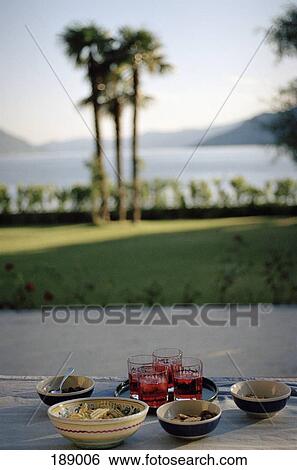 Snack food and drinks on outdoor table at dusk View Large Photo Image Stock Photograph - Snack food and drinks on outdoor table at dusk. Fotosearch