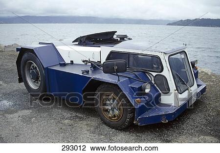 Stock Image - 4x4 vehicle at water’s edge. Fotosearch