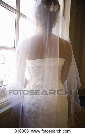 Bride looking out of window View Large Photo Image Stock Image - Bride looking out of window. Fotosearch