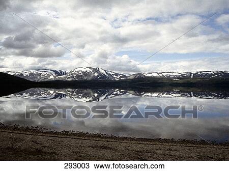 Lake with reflection of snowcapped mountains View Large Photo Image Stock Image - Lake with reflection of snowcapped mountains. Fotosearch