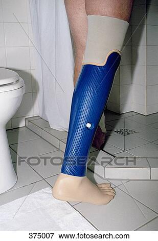 Low section of man getting into shower with prosthetic leg View Large Photo Image Stock Photo - Low section of man getting into shower with prosthetic leg. Fotosearch