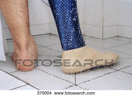 Low section of man showering with prosthetic leg View Large Photo Image Picture - Low section of man showering with prosthetic leg. Fotosearch
