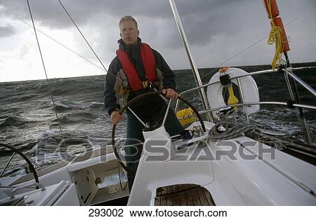 Man at the helm of yacht View Large Photo Image Stock Image - Man at the helm of yacht. Fotosearch