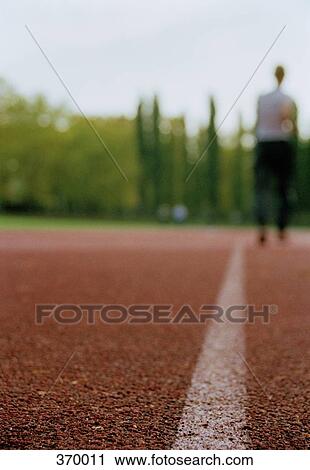 Man standing on running track View Large Photo Image Stock Image - Man standing on running track. Fotosearch