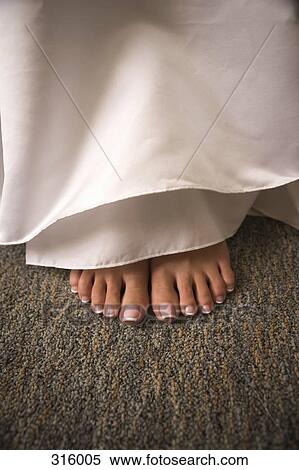 Stock Photography - Pedicured feet below dress. Fotosearch