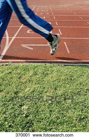 Person jogging on a sports track View Large Photo Image Stock Image - Person jogging on a sports track. Fotosearch