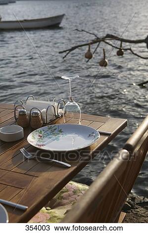Place settings at a table by the sea View Large Photo Image Stock Image - Place settings at a table by the sea. Fotosearch