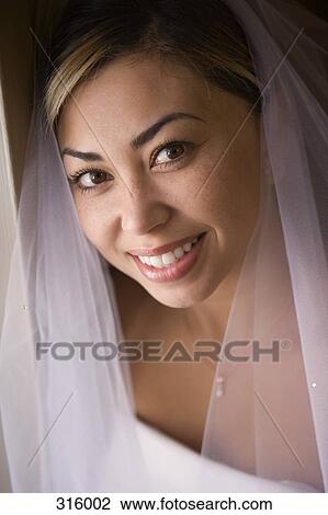 Portrait of bride wearing veil View Large Photo Image Stock Image - Portrait of bride wearing veil. Fotosearch