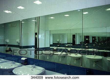 Row of wash basins and mirrors in public bathroom View Large Photo Image Stock Photo - Row of wash basins and mirrors in public bathroom. Fotosearch