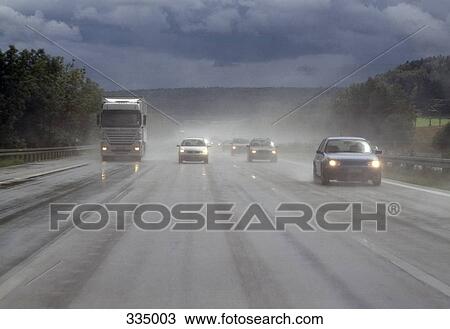 Semi truck and cars traveling on highway in the rain View Large Photo Image Stock Image - Semi truck and cars traveling on highway in the rain. Fotosearch