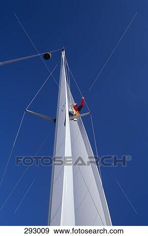 Woman perched on mast of yacht View Large Photo Image Stock Photo - Woman perched on mast of yacht. Fotosearch