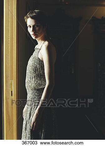 Woman standing in dark room, illuminated by sunlight View Large Photo Image Stock Image - Woman standing in dark room, illuminated by sunlight. Fotosearch