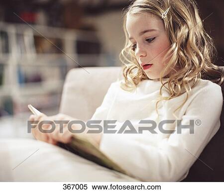 Young girl reading a book View Large Photo Image Stock Photography - Young girl reading a book. Fotosearch