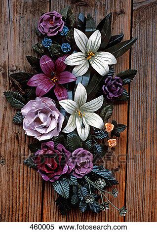 Stock Photography - Bouquet of metal flowers attached to a wooden door. Fotosearch