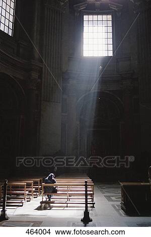 A nun sitting in a church praying View Large Photo Image Picture - A nun sitting in a church praying. Fotosearch