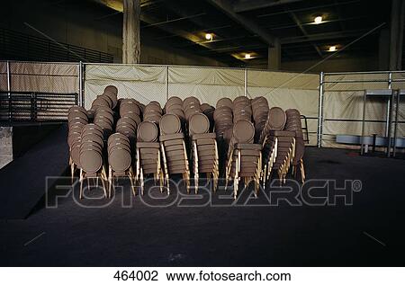 Brown chairs stacked together at an event center View Large Photo Image Stock Image - Brown chairs stacked together at an event center. Fotosearch