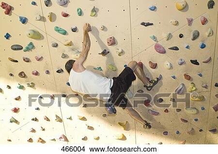 High angle view of a man indoor rock climbing View Large Photo Image Picture - High angle view of a man indoor rock climbing. Fotosearch
