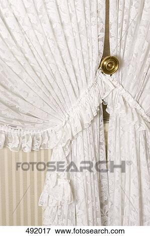 Detail of lace curtains drawn back View Large Photo Image Stock Photo - Detail of lace curtains drawn back. Fotosearch