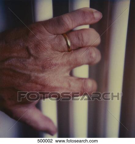 Detail of an elderly man holding bars View Large Photo Image Stock Image - Detail of an elderly man holding bars. Fotosearch
