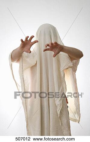 Stock Image - A person standing underneath a white sheet. Fotosearch