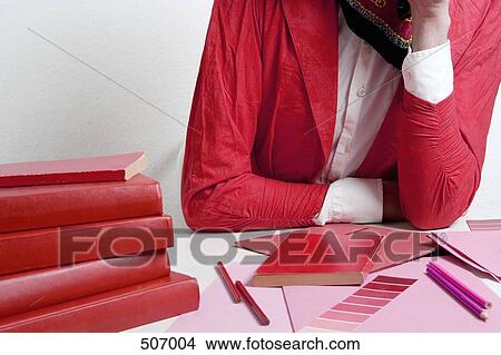Woman leaning on a desk with design materials View Large Photo Image Picture - Woman leaning on a desk with design materials. Fotosearch