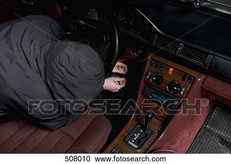 A hooded man starting a car with ignition circuit wires View Large Photo Image Stock Image - A hooded man starting a car with ignition circuit wires. Fotosearch