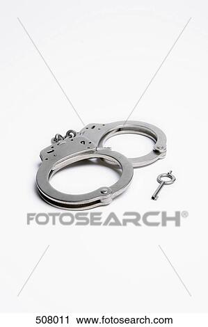 A pair of handcuffs and a key View Large Photo Image Stock Image - A pair of handcuffs and a key. Fotosearch