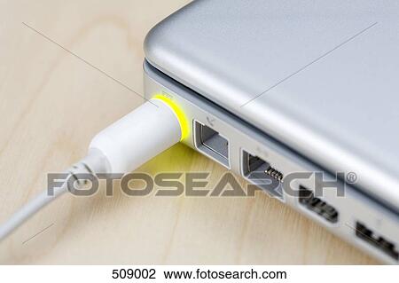 A power cable connected to a closed laptop View Large Photo Image Stock Image - A power cable connected to a closed laptop. Fotosearch