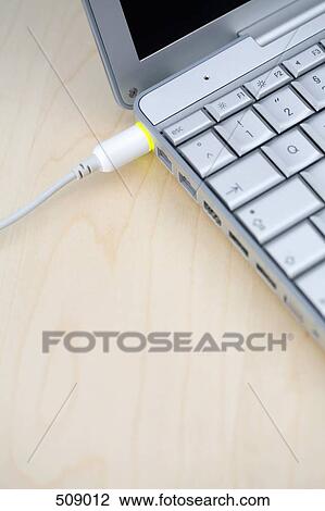 A power cable connected to a laptop View Large Photo Image Stock Image - A power cable connected to a laptop. Fotosearch