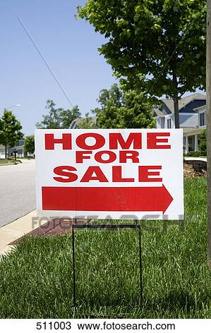 Stock Image - 'Home for sale' sign on the front lawn of a house. Fotosearch