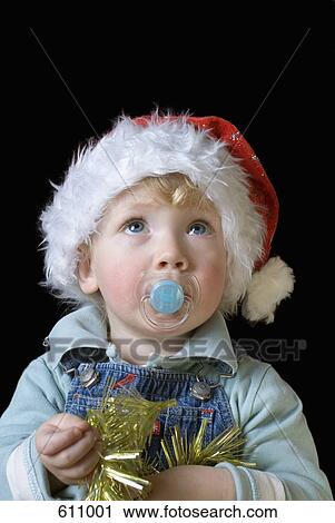A boy wearing a Santa hat View Large Photo Image Stock Image - A boy wearing a Santa hat. Fotosearch