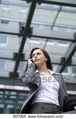 A businesswoman on her mobile phone View Large Photo Image Picture - A businesswoman on her mobile phone. Fotosearch