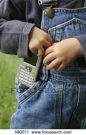 A child carrying a mobile phone View Large Photo Image Stock Image - A child carrying a mobile phone. Fotosearch