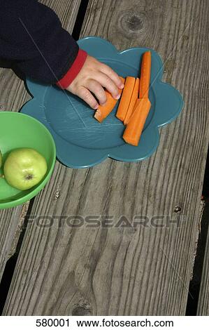 A child reaching for food on a plate View Large Photo Image Stock Image - A child reaching for food on a plate. Fotosearch