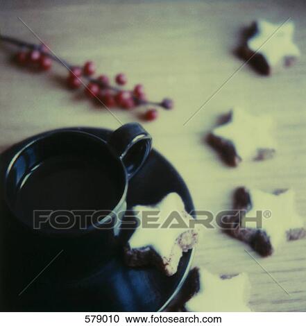 A cup and saucer with star shaped cookies View Large Photo Image Stock Image - A cup and saucer with star shaped cookies. Fotosearch