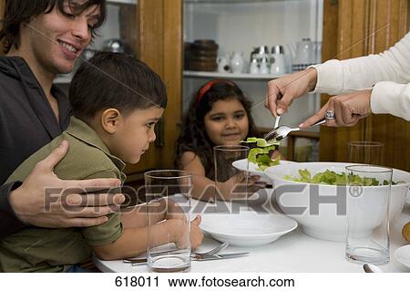 A family having dinner together View Large Photo Image Stock Image - A family having dinner together. Fotosearch