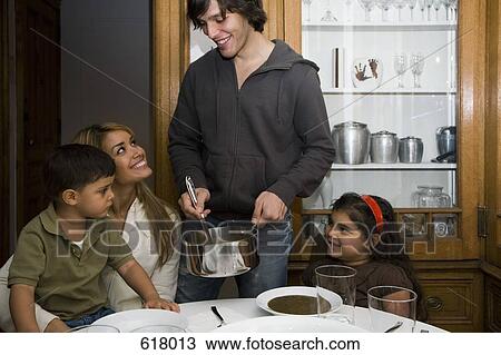 A family having dinner together View Large Photo Image Stock Image - A family having dinner together. Fotosearch