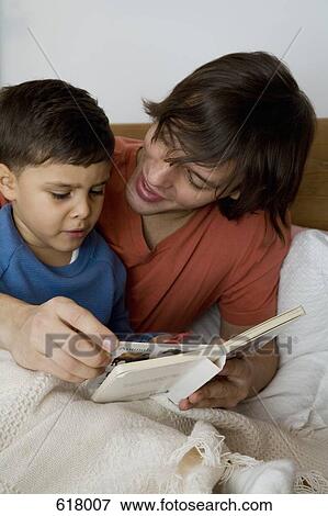 Stock Photo - A father reading to his son. Fotosearch