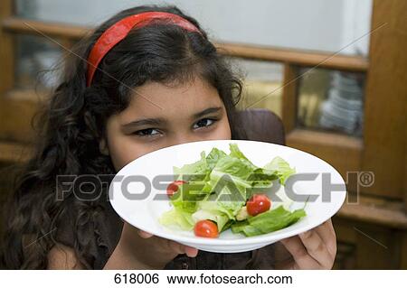 A girl holding a bowl of salad View Large Photo Image Stock Photograph - A girl holding a bowl of salad. Fotosearch