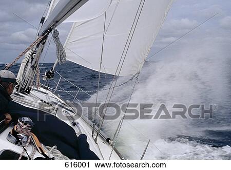 A man steering a yacht in rough weather View Large Photo Image Stock Image - A man steering a yacht in rough weather. Fotosearch