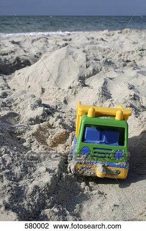 Stock Image - A toy truck on the beach. Fotosearch