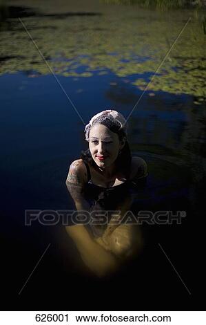A woman bathing in a pond View Large Photo Image Stock Image - A woman bathing in a pond. Fotosearch