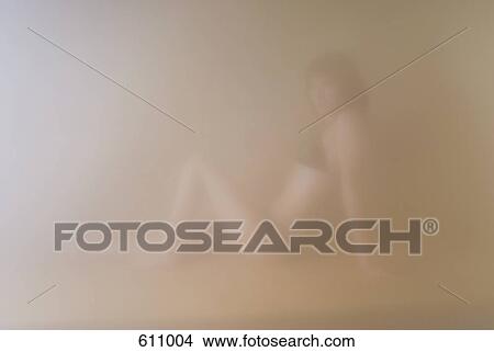 A woman sitting in a sauna View Large Photo Image Picture - A woman sitting in a sauna. Fotosearch