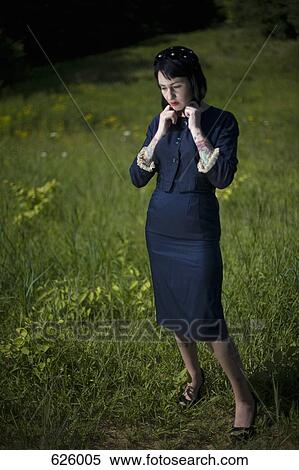 A woman standing in a field View Large Photo Image Stock Photography - A woman standing in a field. Fotosearch