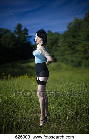 A woman standing in a field wearing old fashioned underwear View Large Photo Image Stock Image - A woman standing in a field wearing old fashioned underwear. Fotosearch