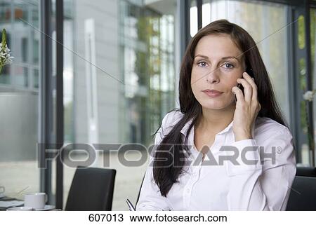 Stock Image - A woman using her mobile phone. Fotosearch
